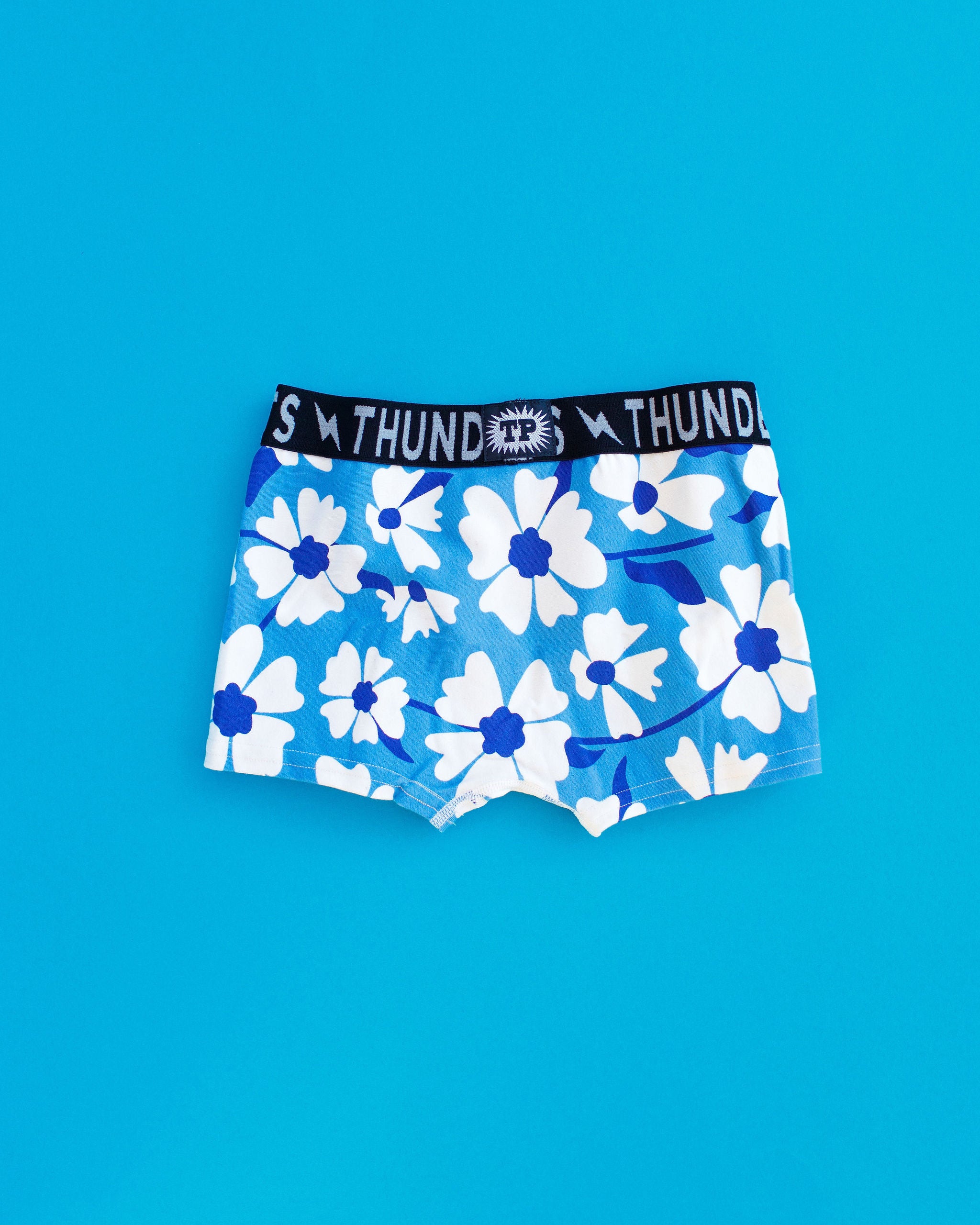 Flat lay of Kids Boxer Brief style underwear in Moody Blues - blue and white flowers.