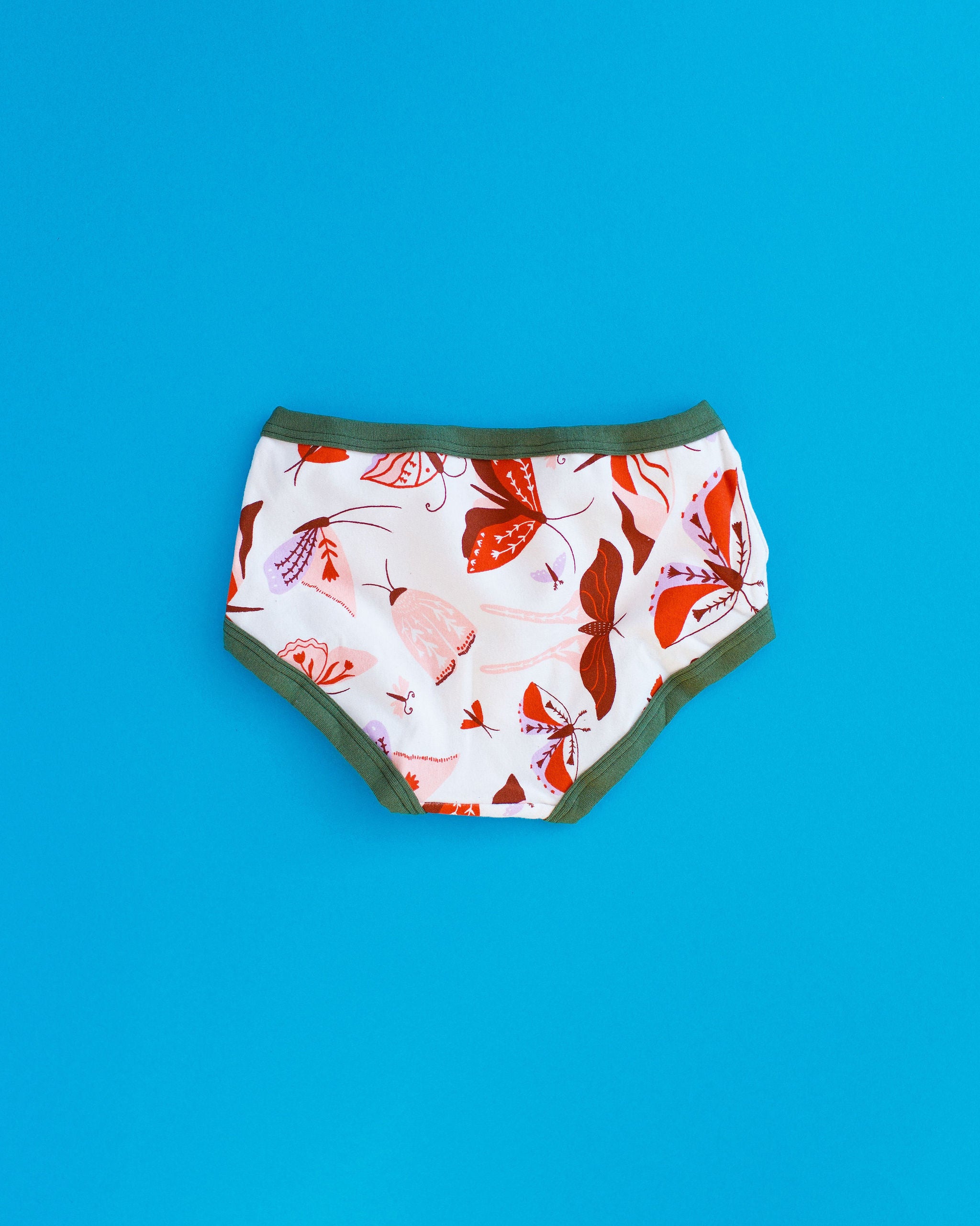 Flat lay of Thunderpants Kids style underwear in Field Study - pink, brown, and orange moths.