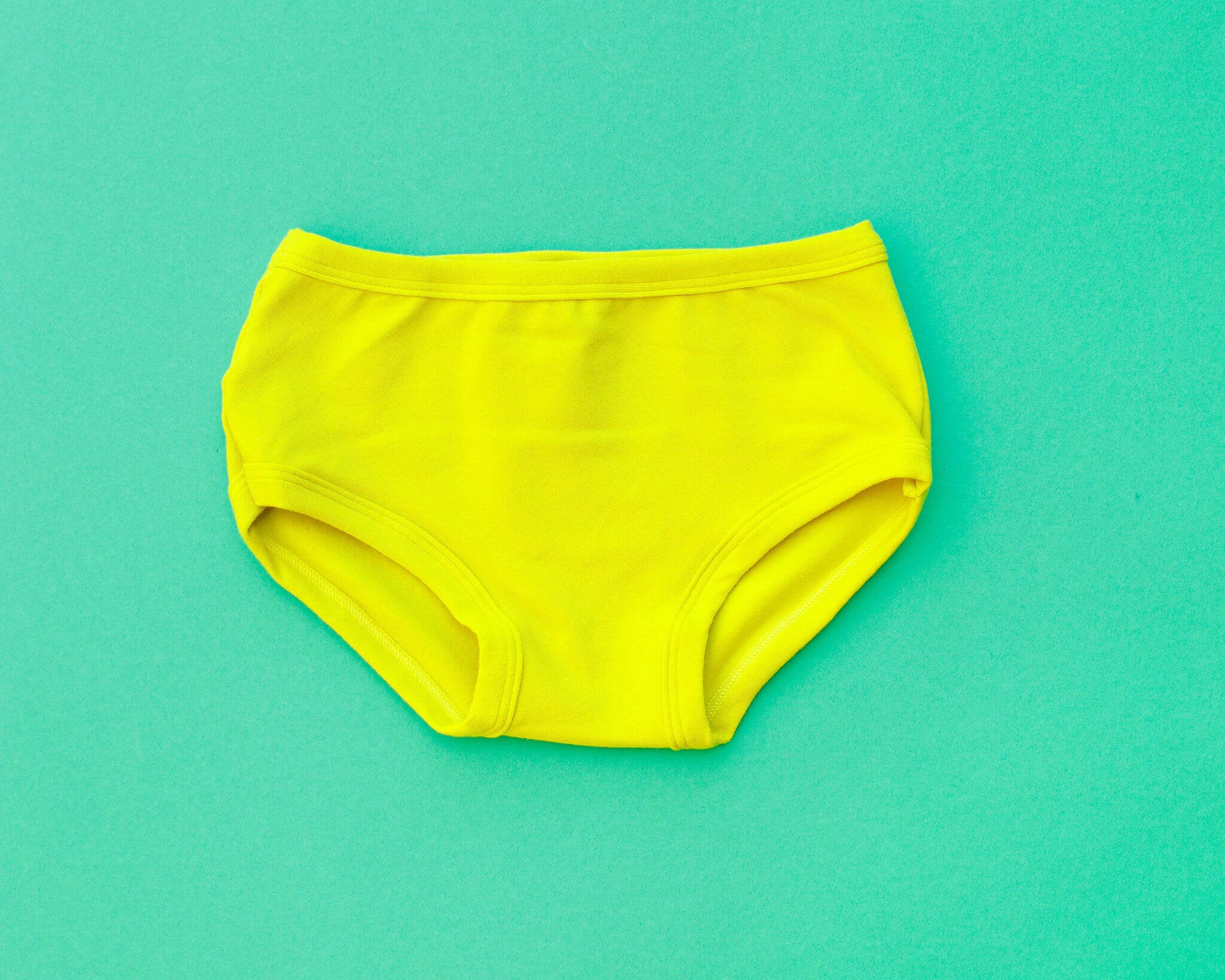 Flat lay of Thunderpants Kid's style underwear in Star Fruit - a yellow chartreuse color.