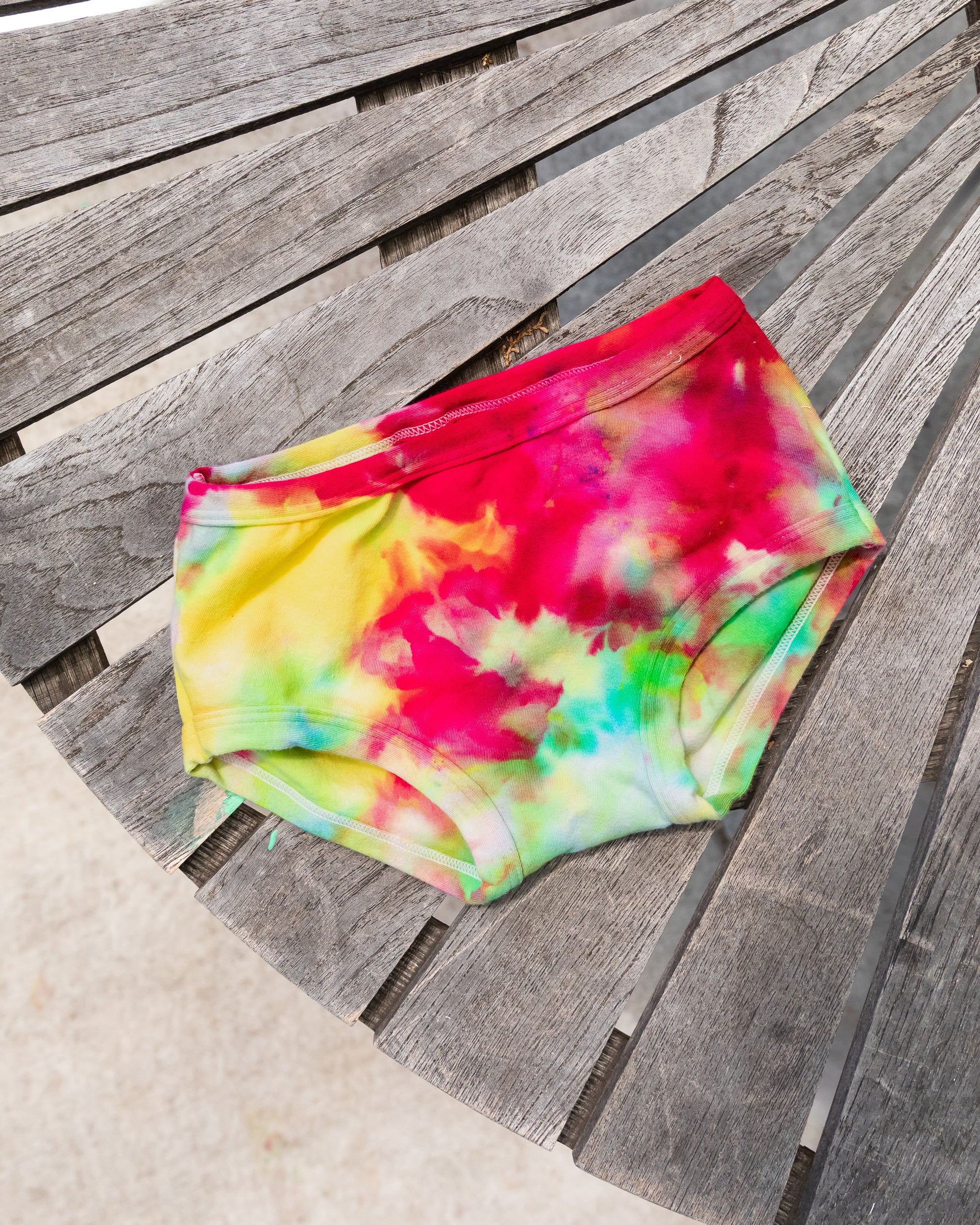 Flat lay of Thunderpants Kid's style underwear in Summer Crush Ice Dye - pinks, blues, yellows. 