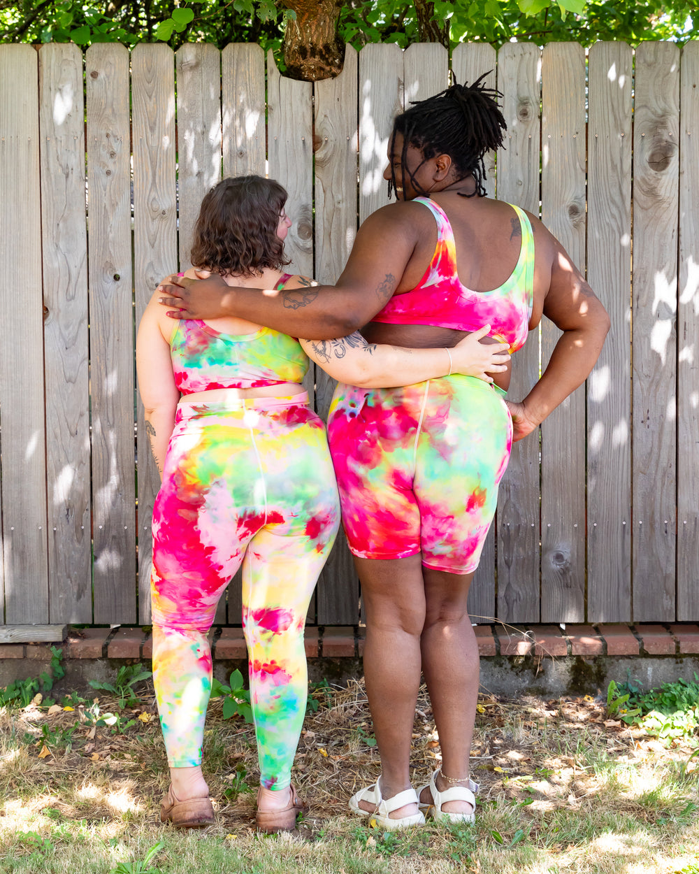 Models wearing various Thunderpants styles in Summer Crush Ice Dye - pink, green, and yellow.