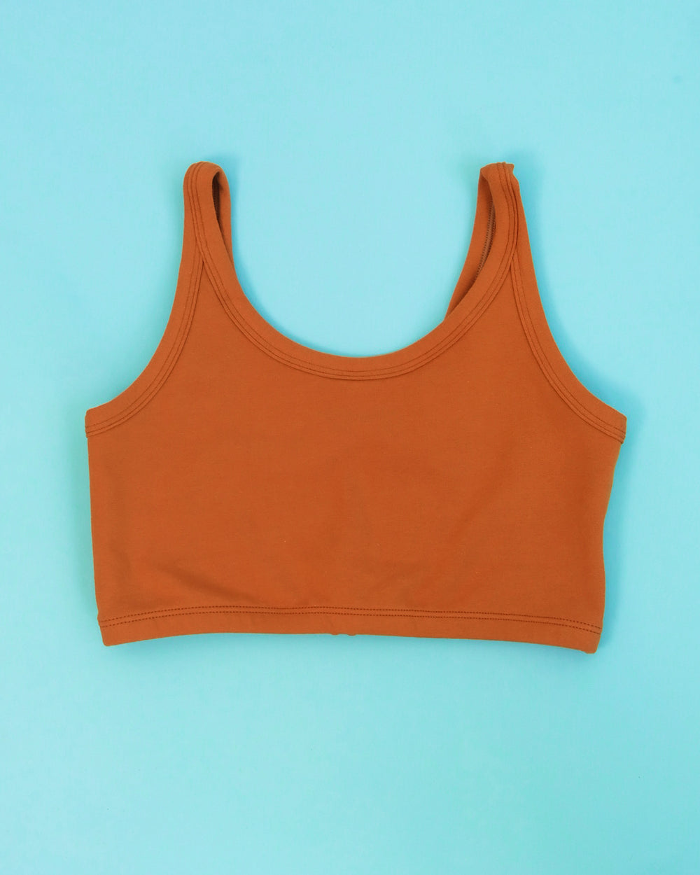 Flat lay of Thunderpants Longline Bra in Lucky Penny - a rust color.