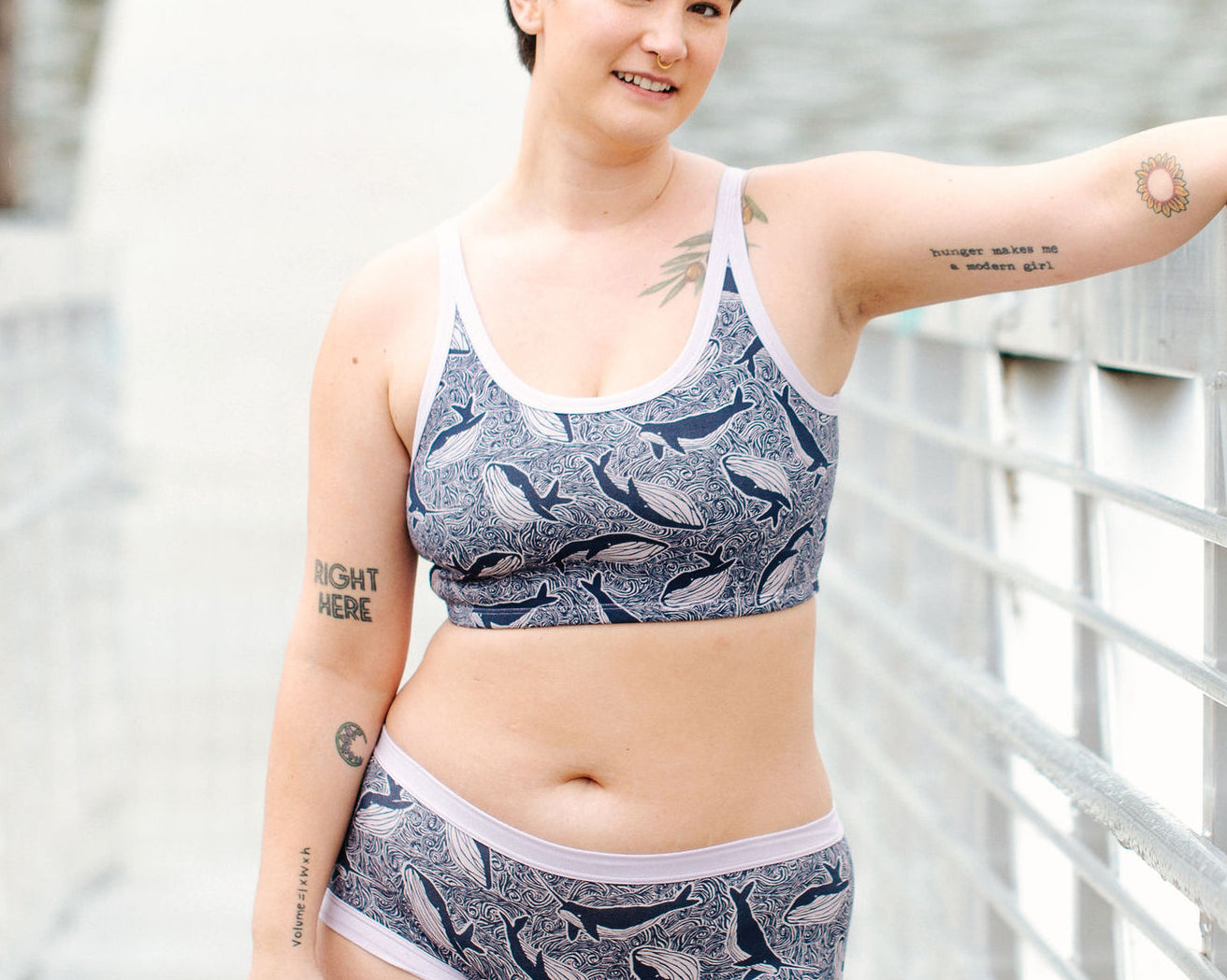 Model wearing Thunderpants Longline Bra  and Hipster style underwear in Whale, Whale, Whale - indigo whales on lavender.