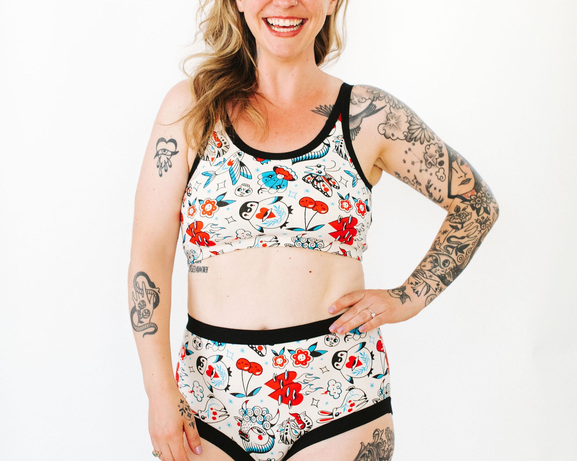 Model wearing Thunderpants Original style underwear and Longline Bra in Inked Up - a tattoo pattern with black, red, and blue. 