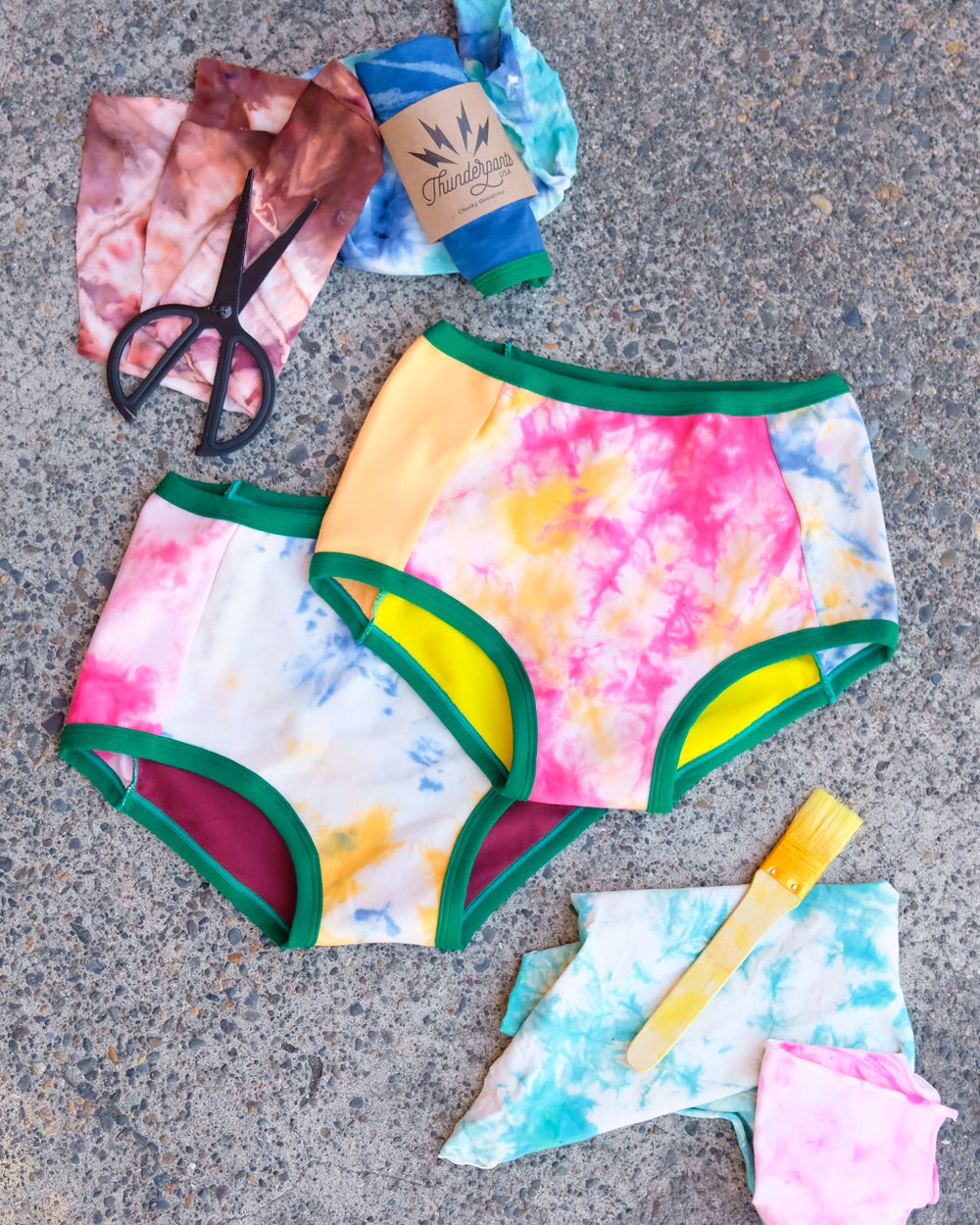 Flat lay of two Thunderpants Original style underwear in Dye Scrap Panel Pants - a mix of solids and dyed fabrics.