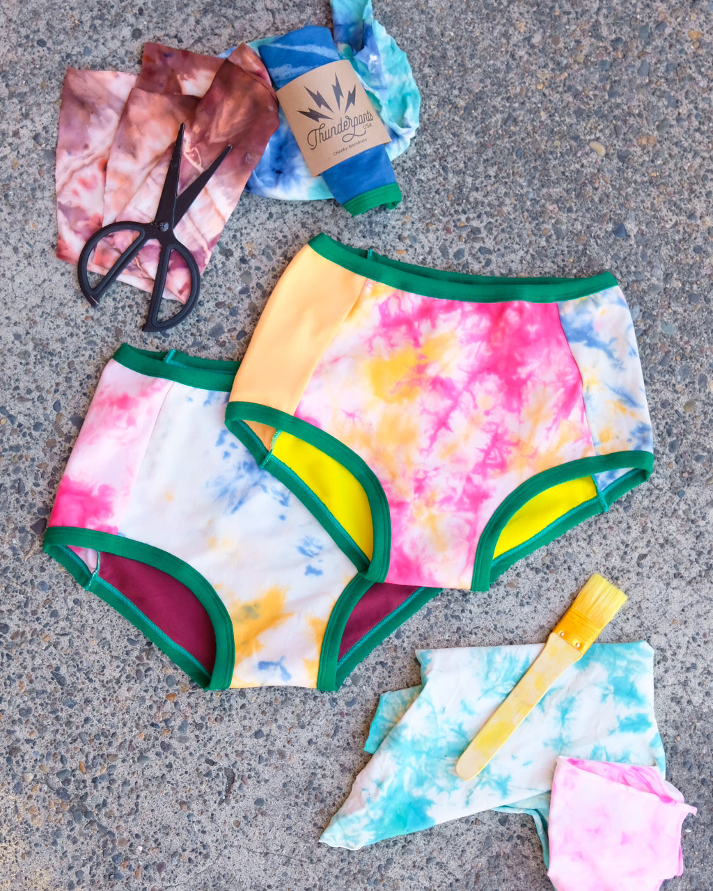 Flat lay of two Thunderpants Original style underwear in Dye Scrap Panel Pants - a mix of solids and dyed fabrics.