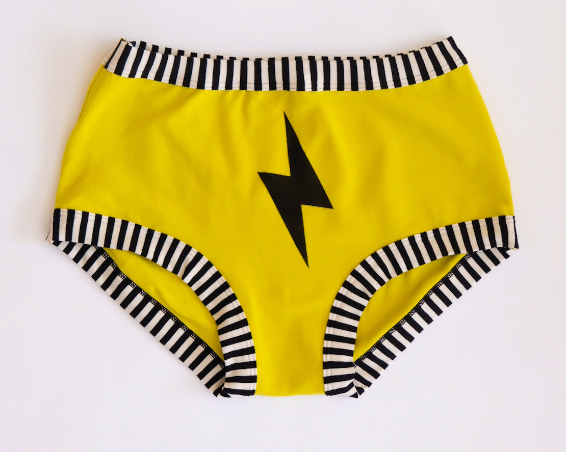 Flat lay of Thunderpants Original style underwear in Thunderstruck - yellow with a black lightning bolt.