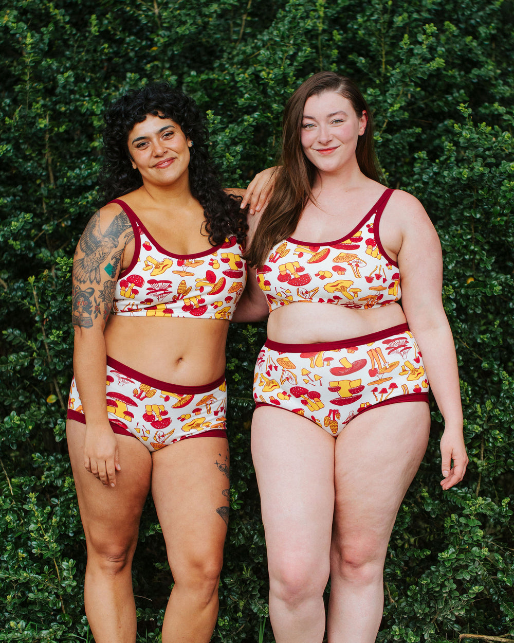 Two models wearing Thunderpants Original style underwear  and Longline Bra in Whadda Fungi - red, orange, and yellow mushroom print.