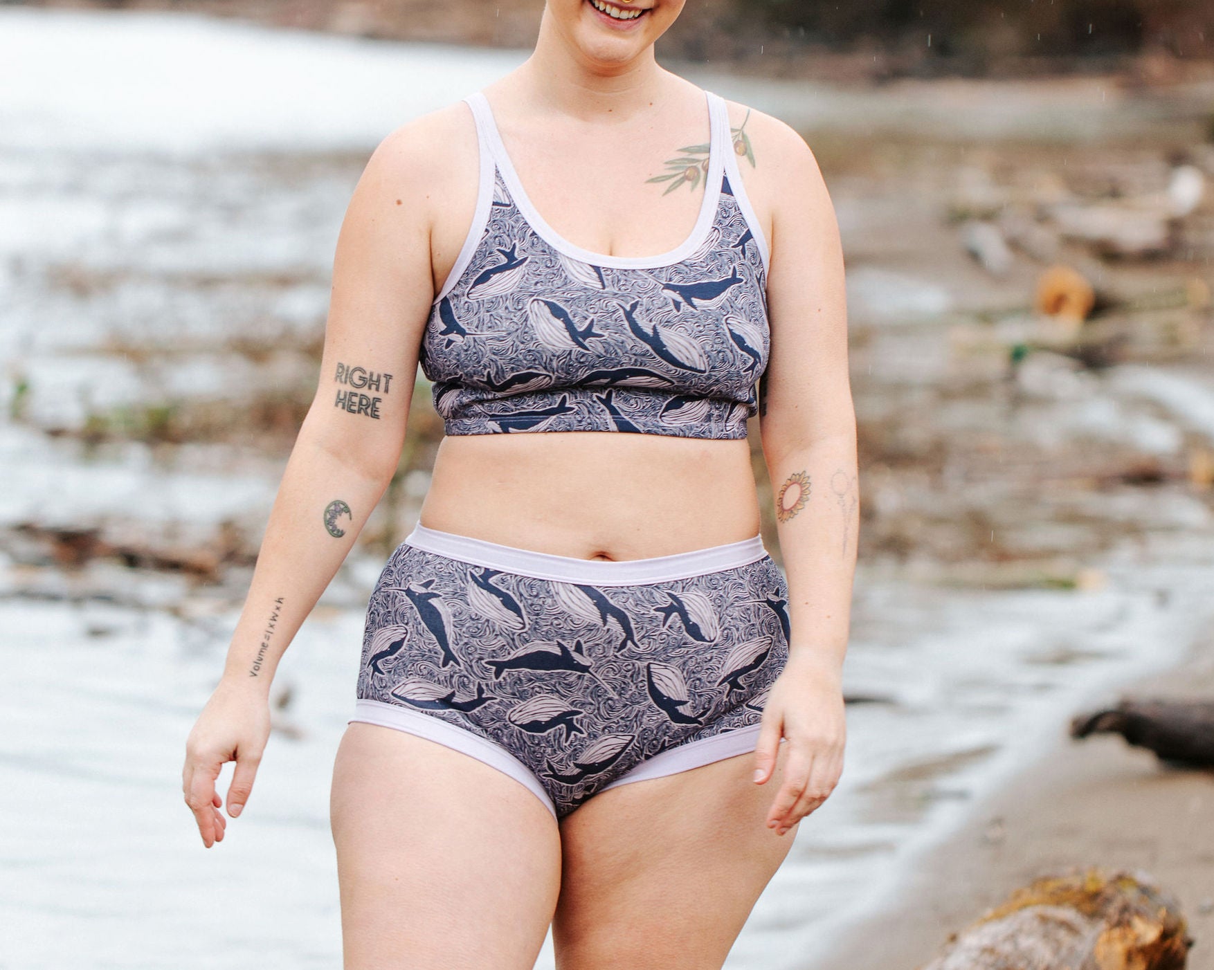 Model wearing Thunderpants Original style underwear and Longline Bra in Whale, Whale, Whale print - indigo whales on lavender.