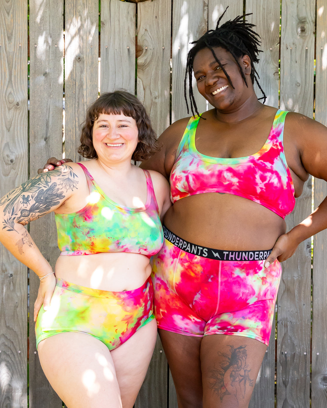 Models wearing various Thunderpants styles in Summer Crush Ice Dye - pinks, blues, yellows. 