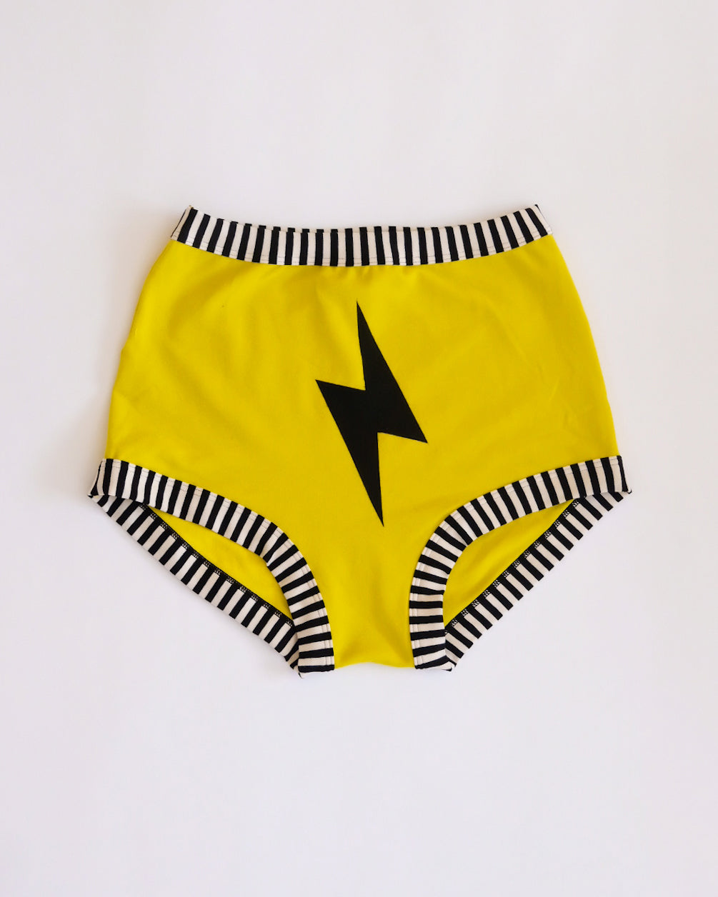 Flat lay of Thunderpants Sky Rise style underwear in Thunderstruck - yellow with a black lightning bolt.