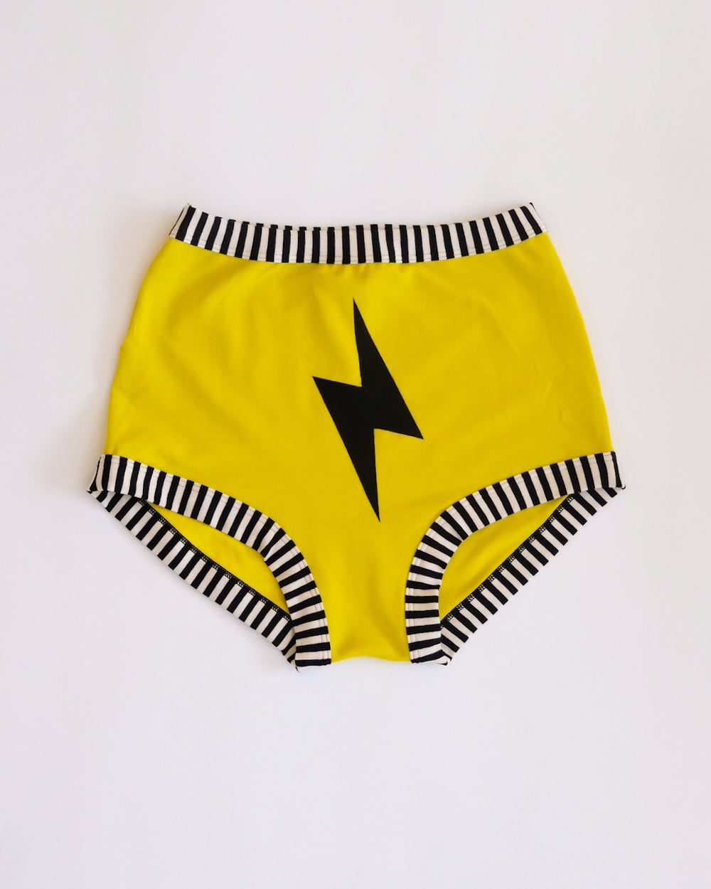 Flat lay of Thunderpants Sky Rise style underwear in Thunderstruck - yellow with a black lightning bolt.