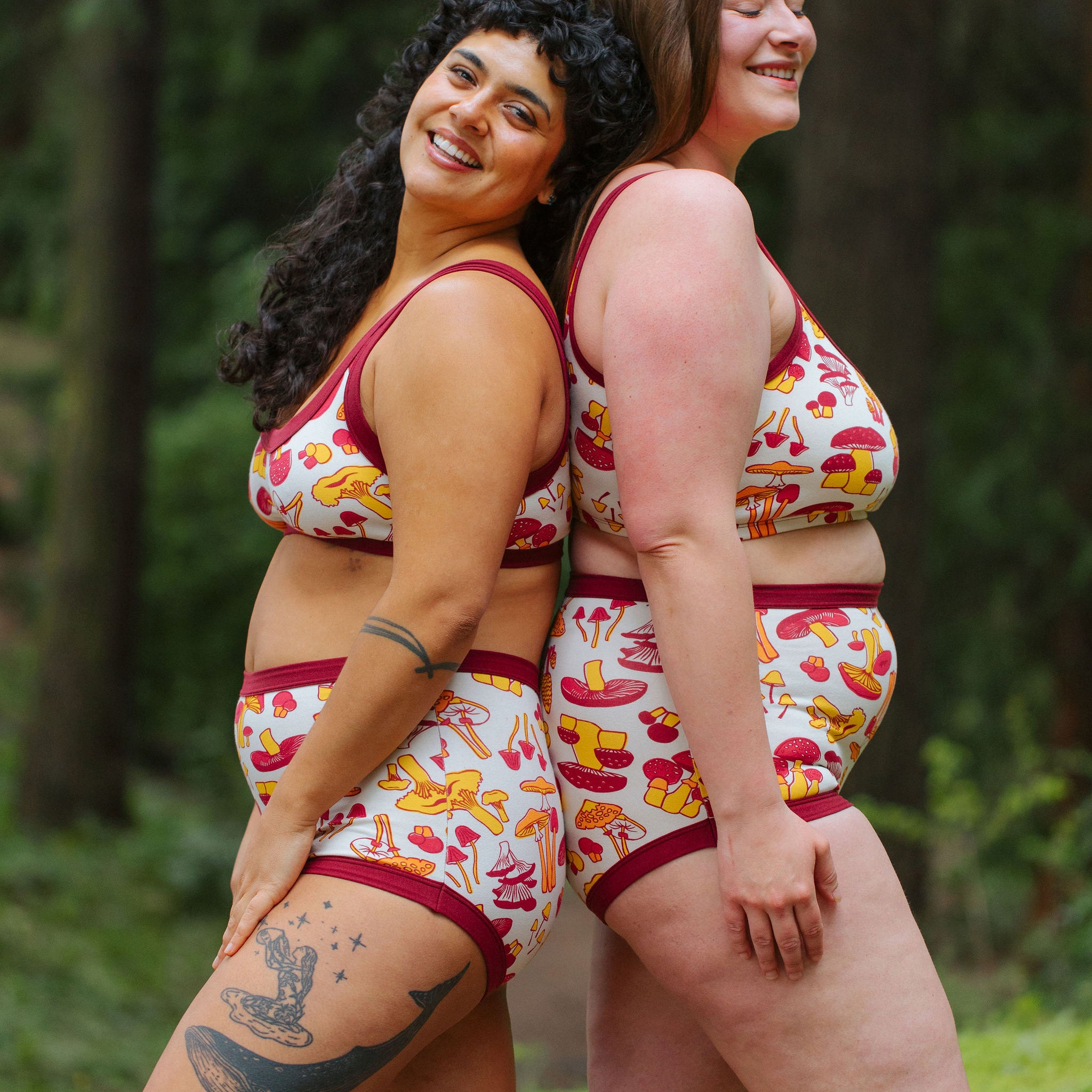 Two models wearing Thunderpants Sky Rise style underwear and Bralette in Whadda Fungi print - red, yellow, and orange mushroom print.