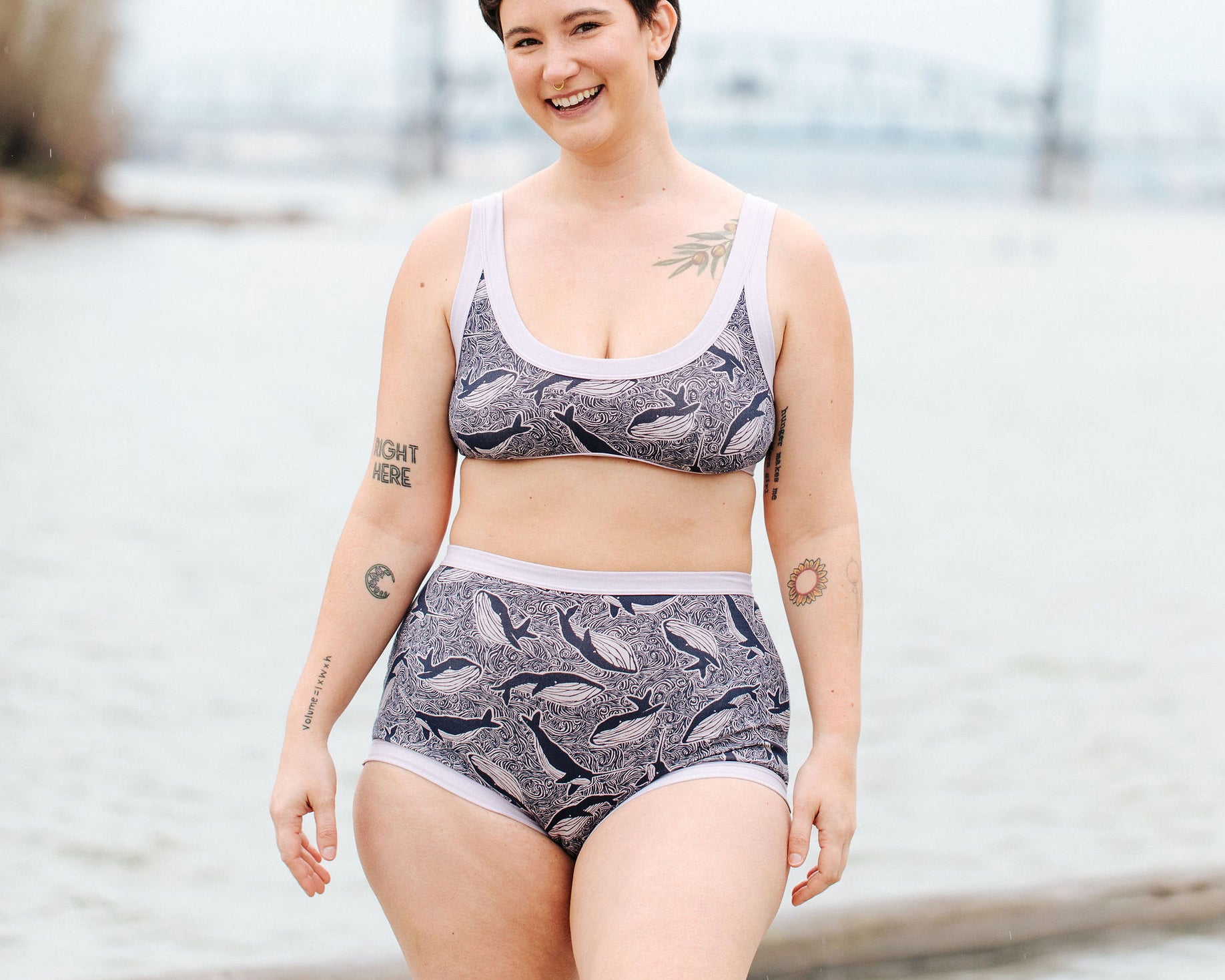 Model wearing Thunderpants Sky Rise style underwear and Bralette in Whale, Whale, Whale print - indigo whales on lavender.