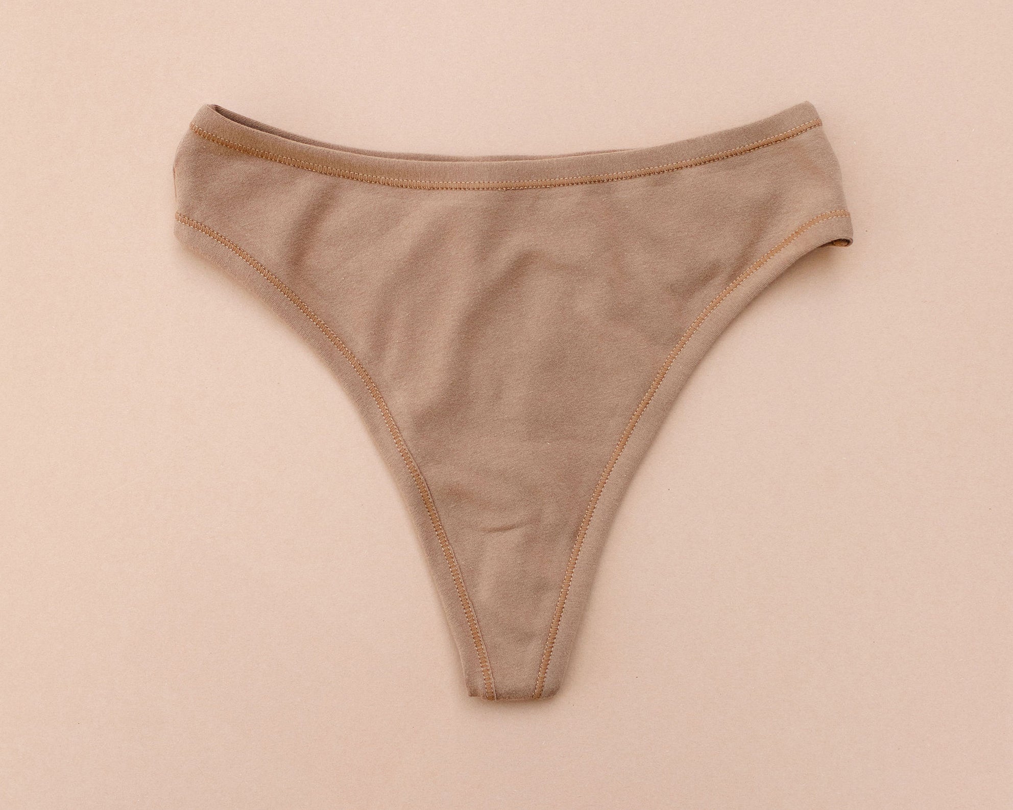 Flat lay of Thunderpants Thong style underwear in Hazelnut - a mid-brown color.